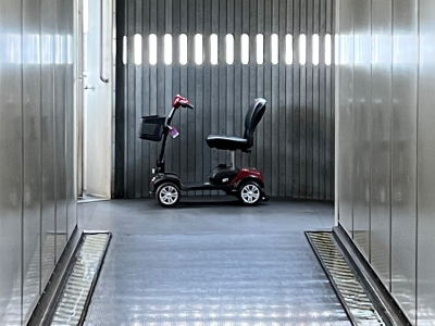 A scooter near an airplane loading door