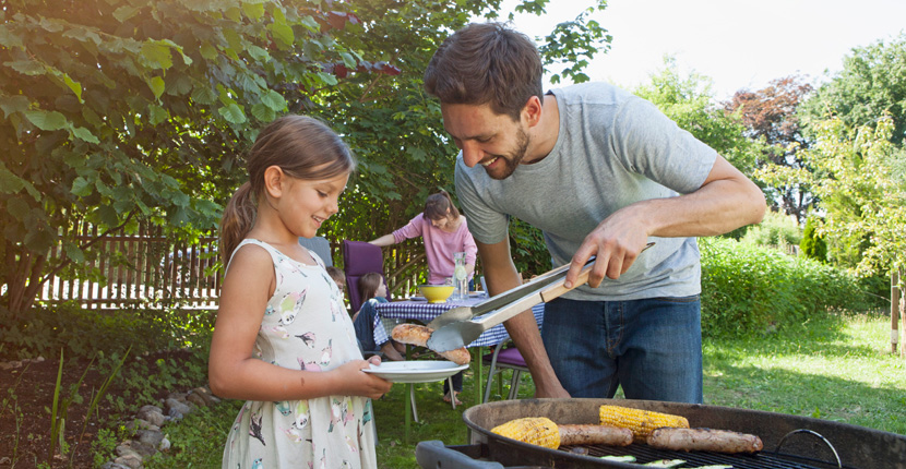 Family barbecuing in the yard