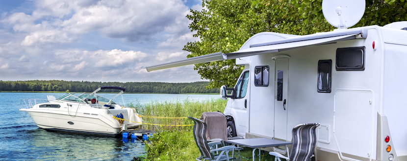 RV near the waters edge with a boat docked