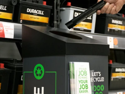 Putting a spent battery into a recycling container