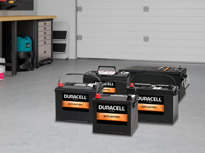 Different sized SLI batteries sitting in a garage