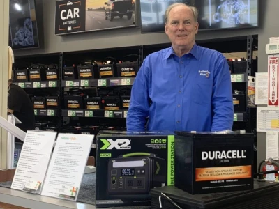 Franchisee Chris Shea standing behind the counter