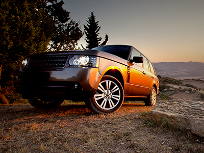 An SUV on rocky terrain at dusk