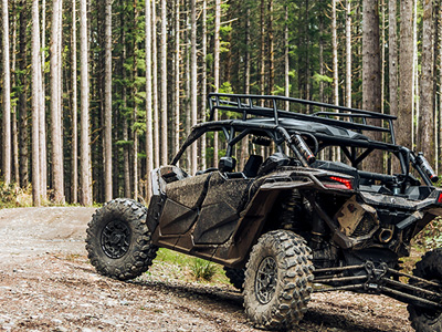 driving through a wooded area in a UTV