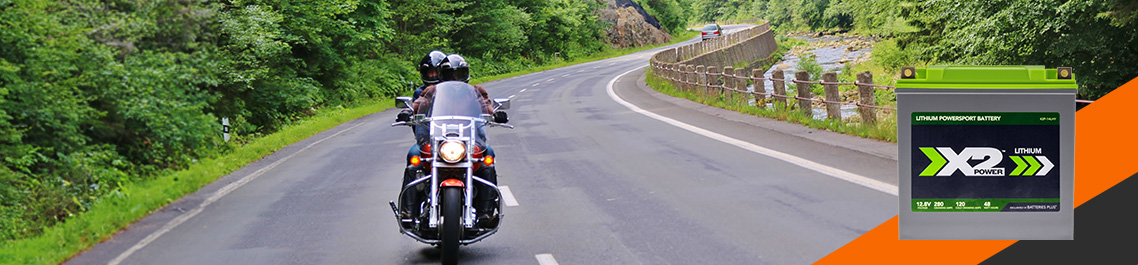 2 people riding a motorcycle on road, Lithium battery hero