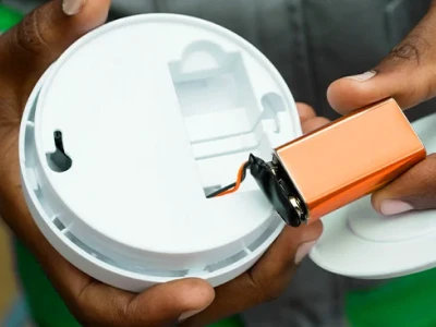 Replacing a smoke or carbon monoxide detector battery.