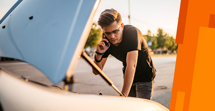 Guy on the phone looking inside car hood