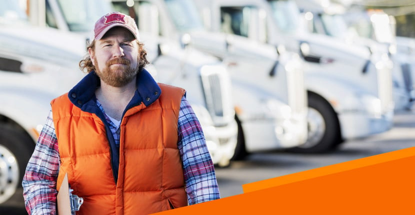 Man standing in front of a line of trucks