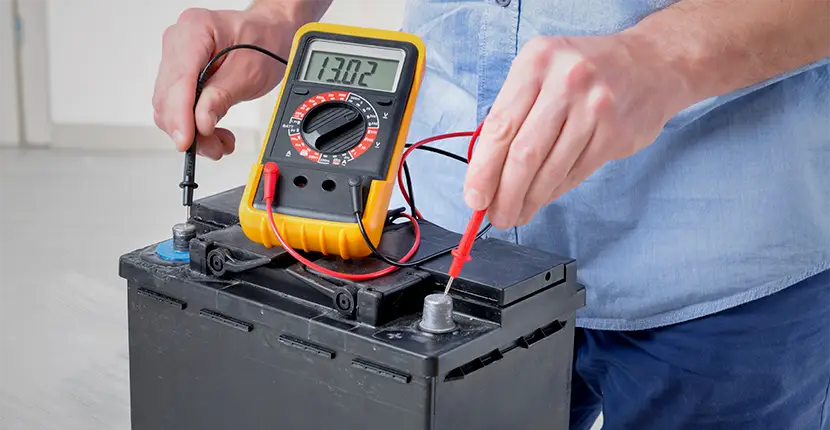 Using a multimeter to test the voltage of a car battery