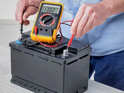 Using a multimeter to test the voltage of a car battery