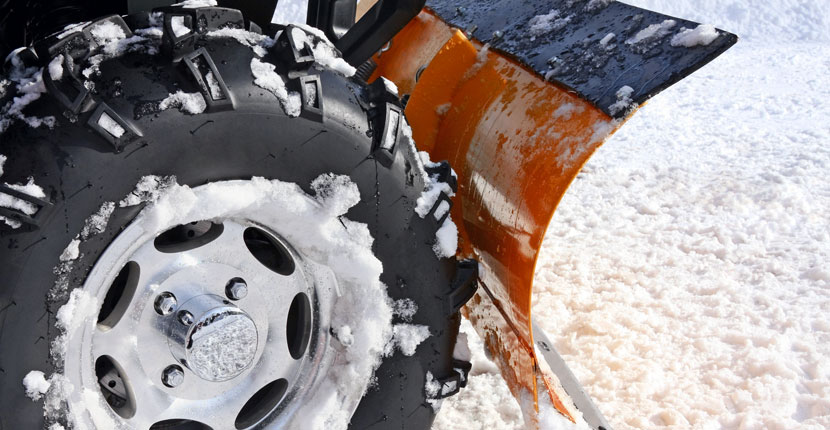 plowing snow with an ATV