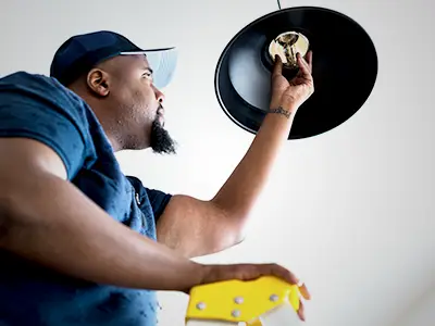 Electrician replacing a bulb