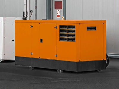 Large orange generator in a warehouse